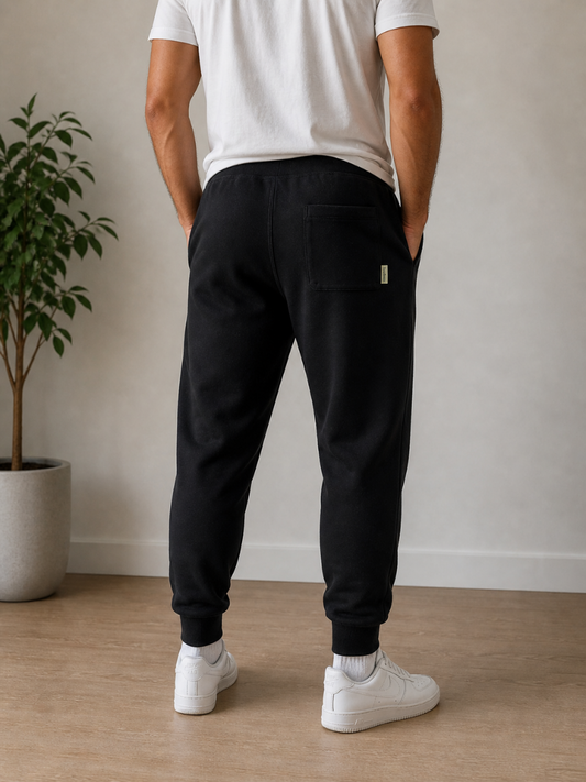 Person wearing black jogger pants with a back pocket and white sneakers. Hemp Horizon