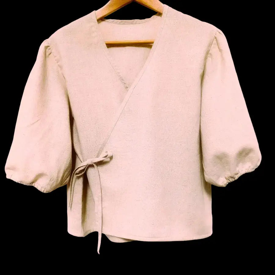 Beige jacket on a hanger against a plain background-Hemp Horizon