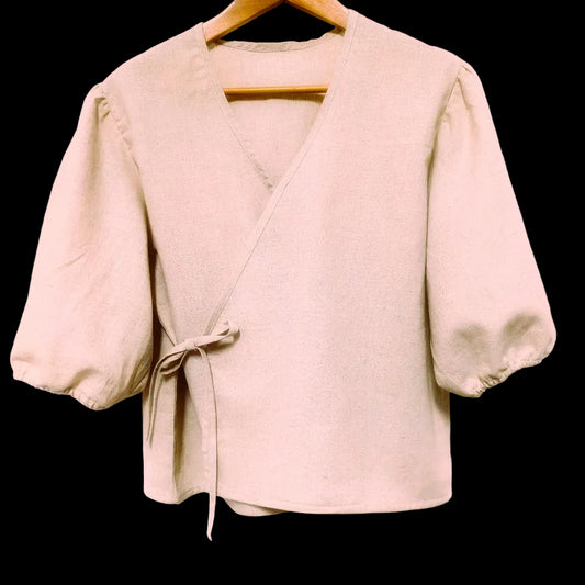 Beige jacket on a hanger against a plain background-Hemp Horizon
