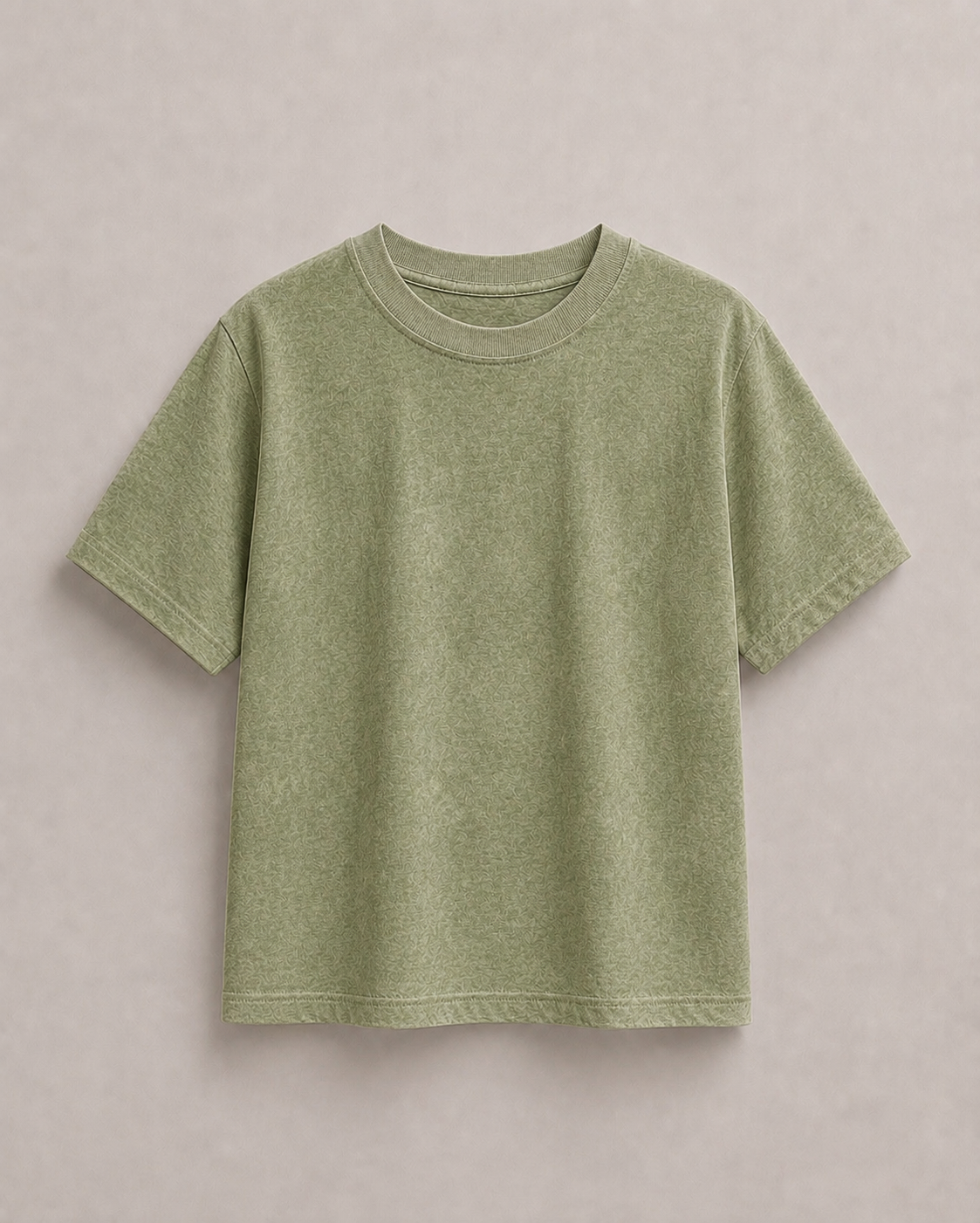 A short-sleeve crewneck t-shirt in a light solive green color, laid flat against a neutral light gray background. Hemp Horizon
