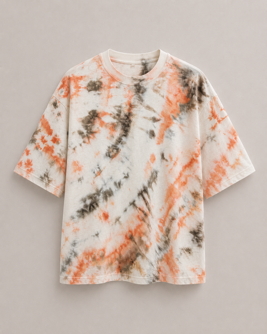 A short-sleeve ice dyed t-shirt with an orange and brown dye twirl pattern, displayed flat against a neutral gray background. Hemp Horizon
