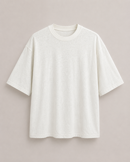 A plain natural short-sleeve boxy crewneck t-shirt displayed flat against a solid, light beige background.